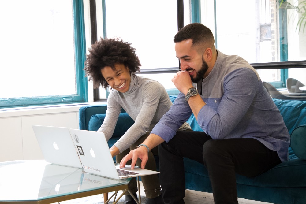 man and woman working on laptops