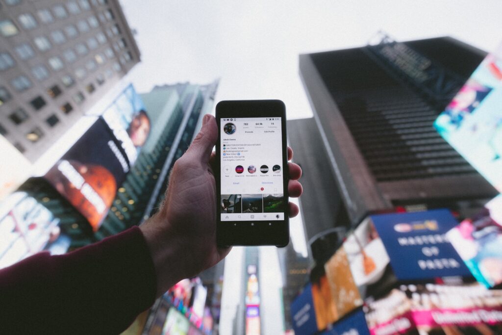 person holding a phone with instagram